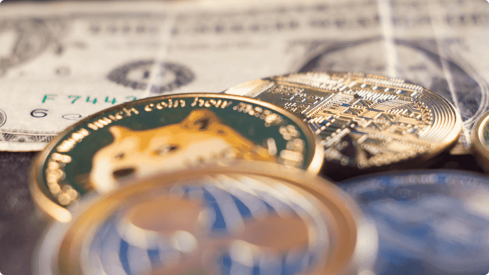 Crypto coins place above a $1 American bill