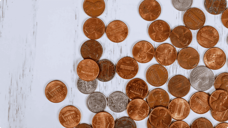 an image of Many-pennies-placed-on-a-counter-representing-penny-stocks-for-2025