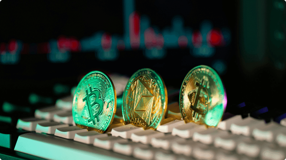 an image of crypto coins in between a keyboard