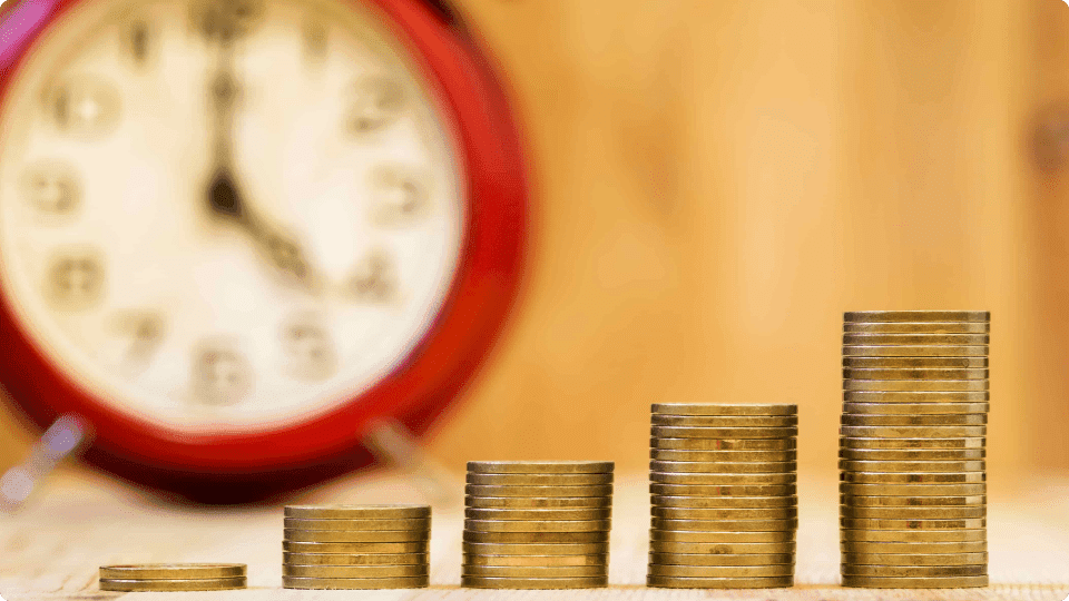 an image of Clock blurred into the background behind coins